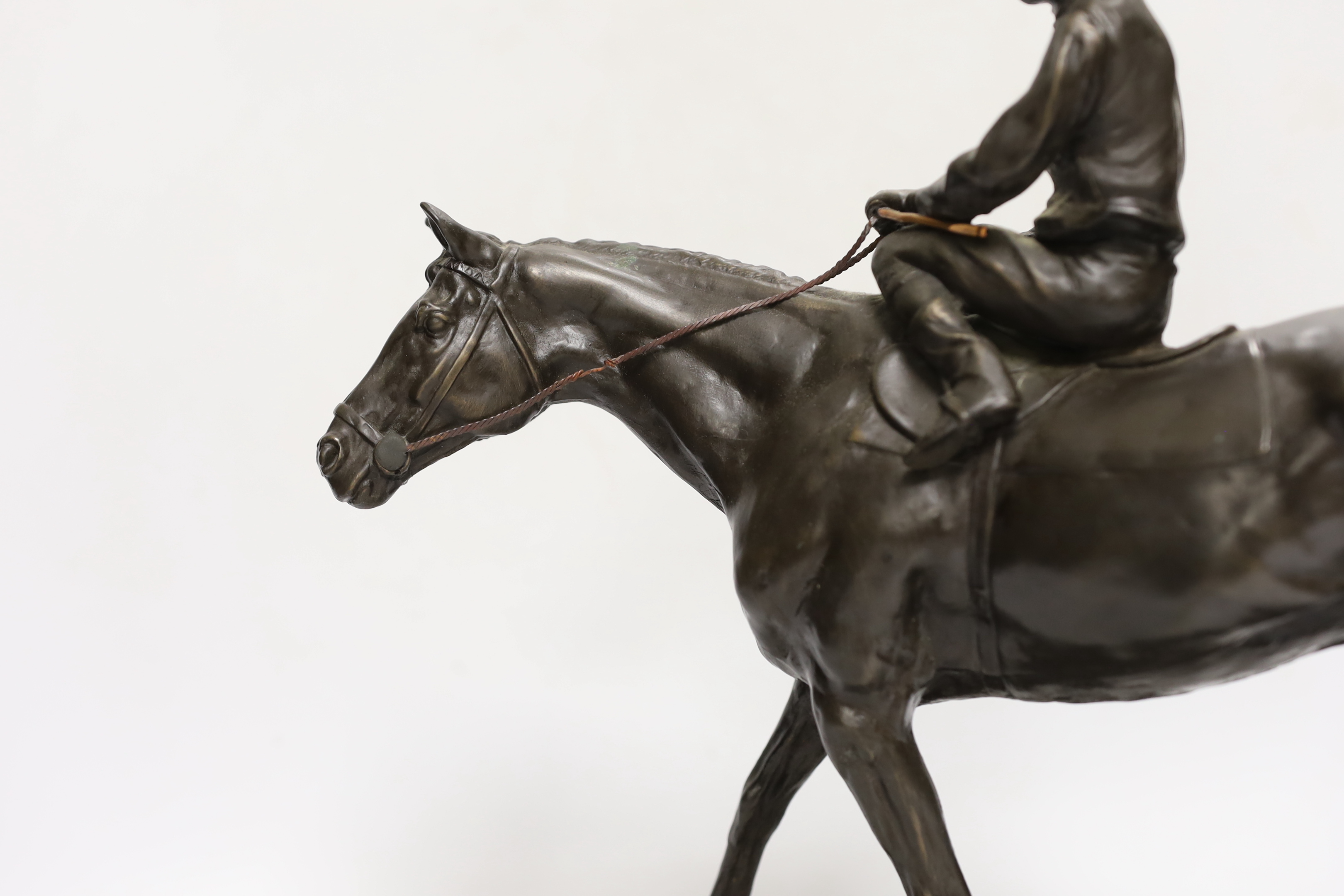 A bronzed resin racehorse and jockey figure group, 33cm high